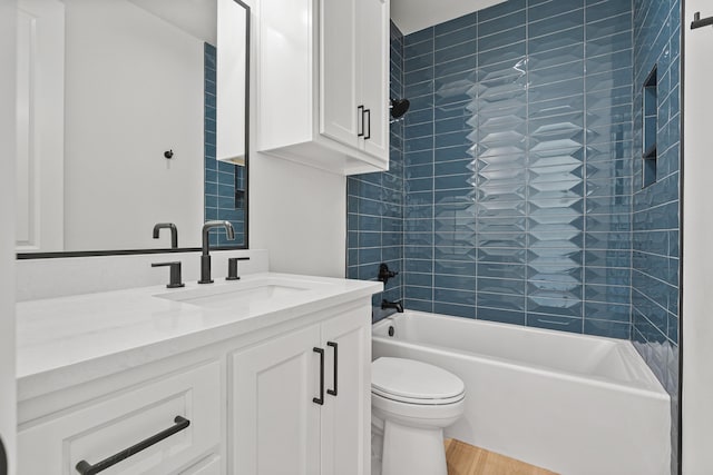 full bathroom with tiled shower / bath, vanity, toilet, and wood-type flooring