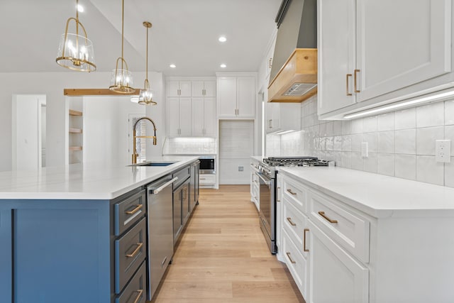 kitchen featuring pendant lighting, a large island, appliances with stainless steel finishes, custom range hood, and white cabinets