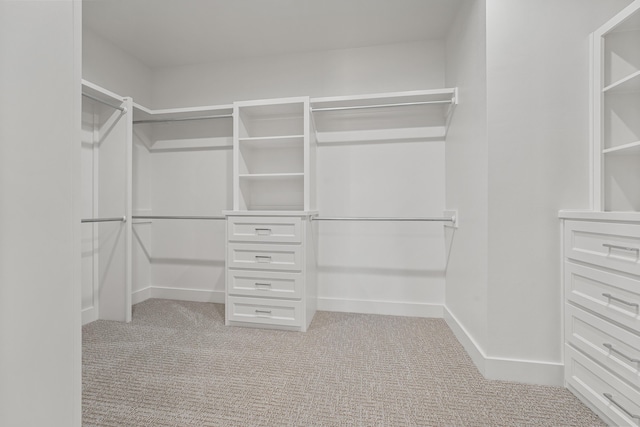 walk in closet with light colored carpet