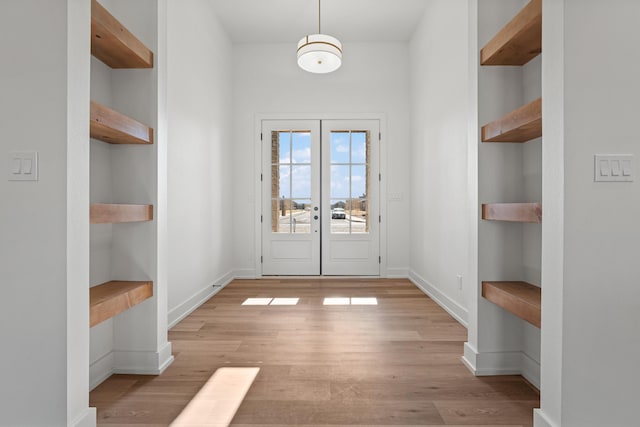 doorway to outside with french doors and light wood-type flooring