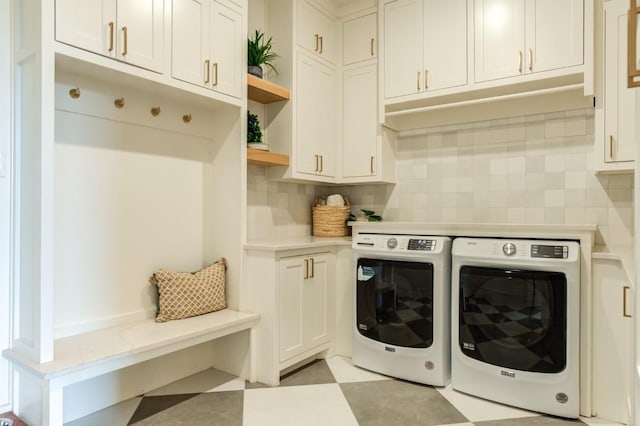 laundry room with cabinets and washer and clothes dryer