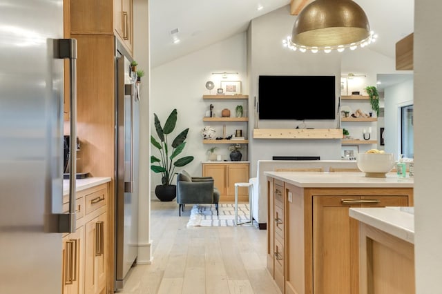 kitchen with lofted ceiling, high quality fridge, stainless steel fridge, and light hardwood / wood-style floors