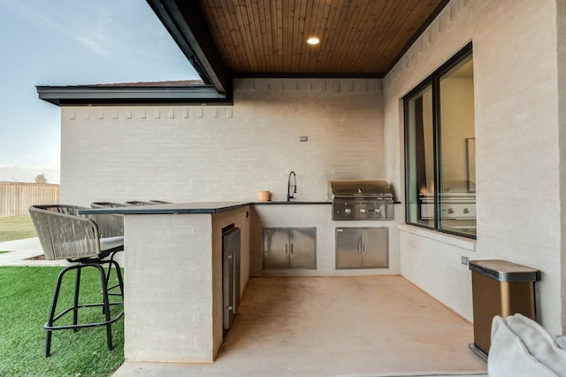 view of patio / terrace featuring a grill, area for grilling, and sink