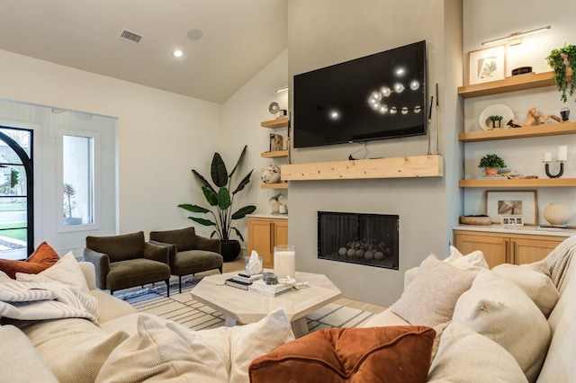 living room with vaulted ceiling and built in features