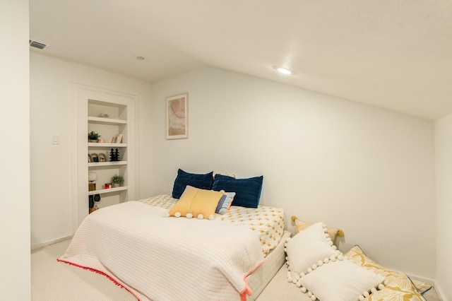 carpeted bedroom featuring lofted ceiling