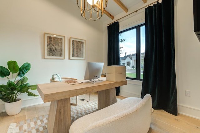 office area with beam ceiling, a notable chandelier, and light hardwood / wood-style floors