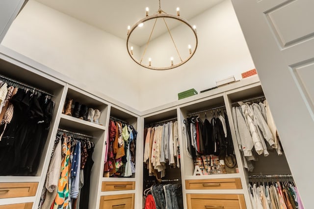 spacious closet with a notable chandelier