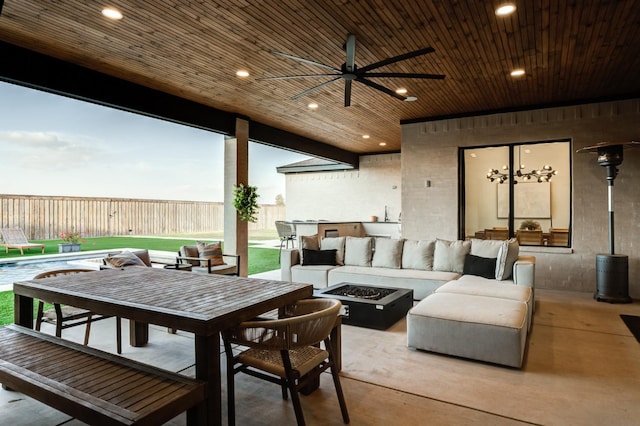 patio terrace at dusk with an outdoor living space with a fire pit and ceiling fan