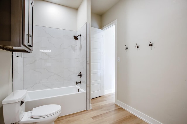 full bath featuring toilet, shower / tub combination, baseboards, and wood finished floors