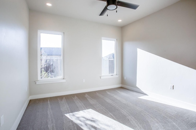 carpeted spare room featuring recessed lighting, a ceiling fan, and baseboards