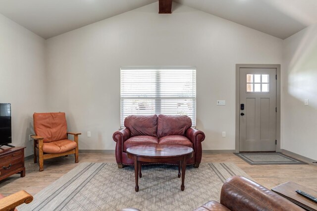 living room featuring vaulted ceiling and light wood-type flooring