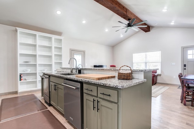 kitchen with sink, gray cabinetry, lofted ceiling with beams, light hardwood / wood-style floors, and a center island with sink