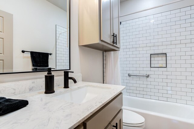 full bathroom featuring vanity, toilet, and tiled shower / bath combo