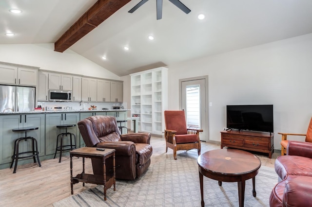 living room with vaulted ceiling with beams, light hardwood / wood-style flooring, and ceiling fan