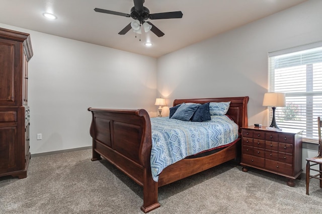 bedroom with ceiling fan and light carpet