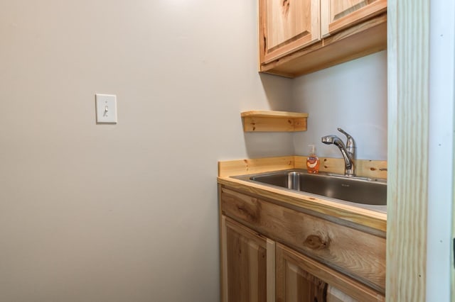 interior space featuring light brown cabinetry and sink