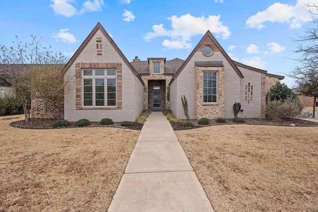 tudor house featuring brick siding