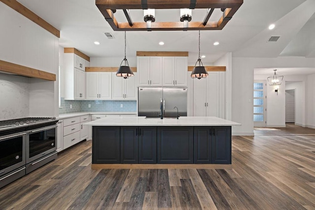 kitchen featuring white cabinetry, visible vents, appliances with stainless steel finishes, and light countertops