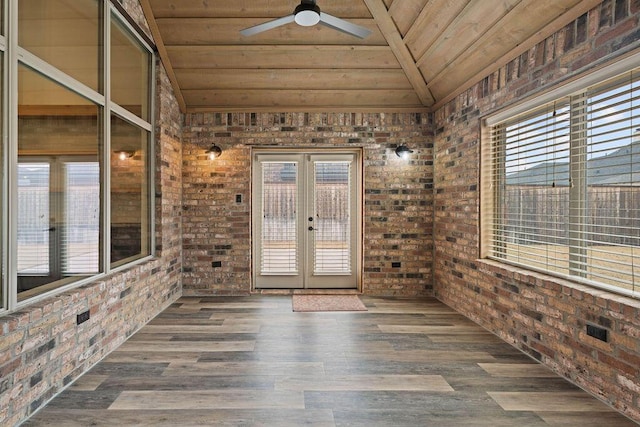 unfurnished sunroom featuring ceiling fan, french doors, wooden ceiling, and lofted ceiling