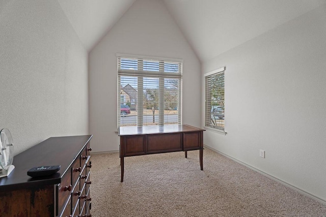 carpeted office space featuring high vaulted ceiling