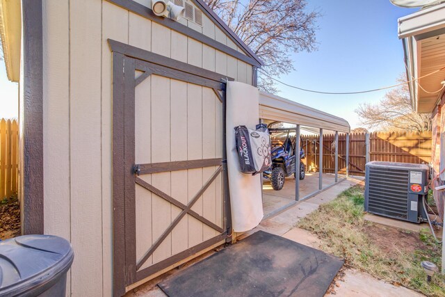 6910 Freeport Ave, Lubbock, TX 79424 - view of shed featuring cooling unit, fence, and a carport