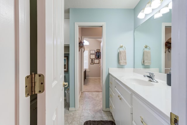 6910 Freeport Ave, Lubbock, TX 79424 - bathroom featuring vanity, tile patterned flooring, and baseboards