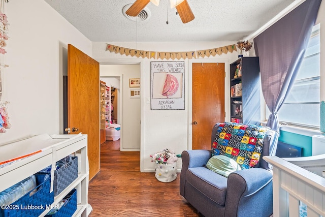 4411 58th St, Lubbock, TX 79414 - living area with a textured ceiling, ceiling fan, and wood finished floors