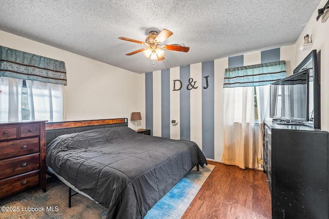 4411 58th St, Lubbock, TX 79414 - bedroom featuring wood finished floors, a textured ceiling, and ceiling fan