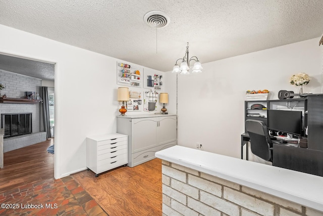 4411 58th St, Lubbock, TX 79414 - dining space with a textured ceiling, a chandelier, and a fireplace