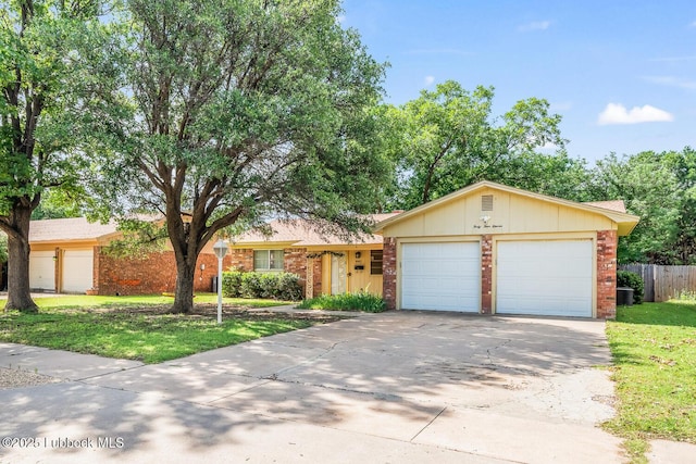 4411 58th St, Lubbock, TX 79414 - view of front of home with concrete driveway, brick siding, and an attached garage