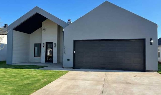 view of front facade with a garage and a front lawn