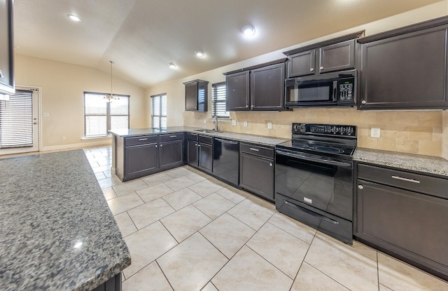 kitchen with sink, decorative light fixtures, vaulted ceiling, dark stone counters, and black appliances