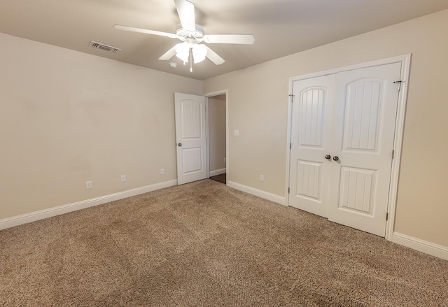 unfurnished bedroom with carpet floors, a closet, and ceiling fan