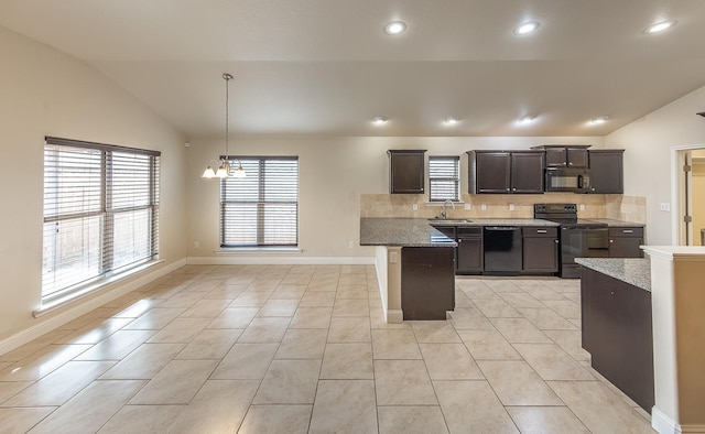 kitchen featuring vaulted ceiling, sink, decorative backsplash, hanging light fixtures, and black appliances