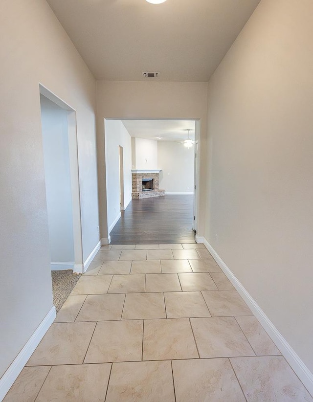 corridor featuring light tile patterned floors