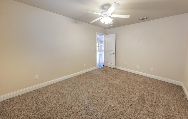 carpeted spare room with ceiling fan