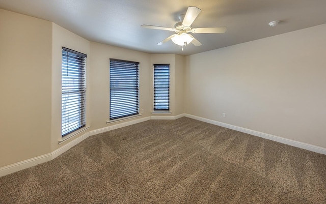 empty room featuring carpet flooring and ceiling fan