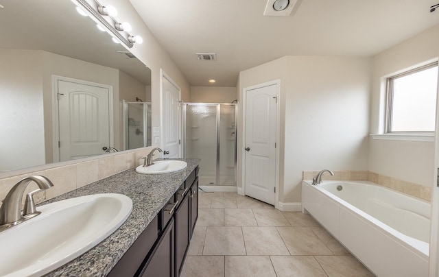 bathroom with tile patterned floors, separate shower and tub, and vanity