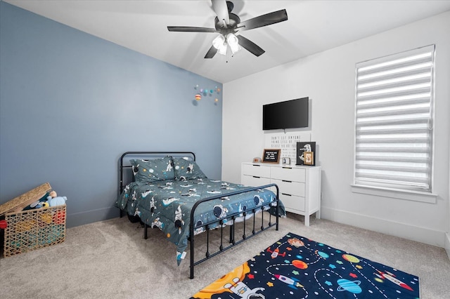 carpeted bedroom with multiple windows and ceiling fan