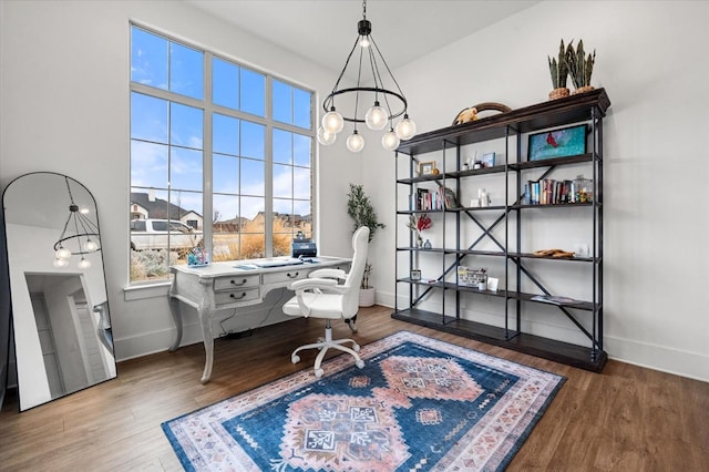 home office featuring hardwood / wood-style flooring and a chandelier