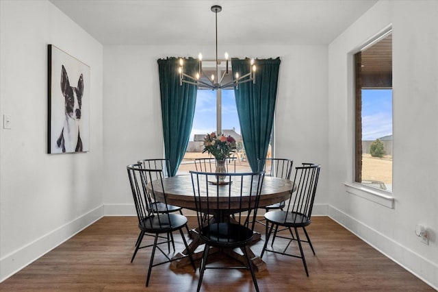 dining area with an inviting chandelier, dark hardwood / wood-style flooring, and a healthy amount of sunlight