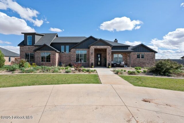1055 Kitty Ln, New Home, TX 79381 - view of front of property featuring brick siding, board and batten siding, and a front lawn