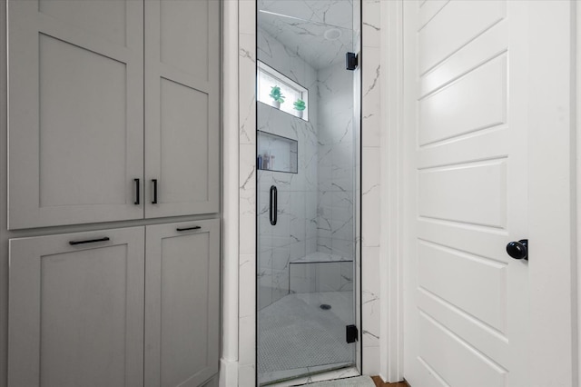 bathroom featuring a shower with shower door