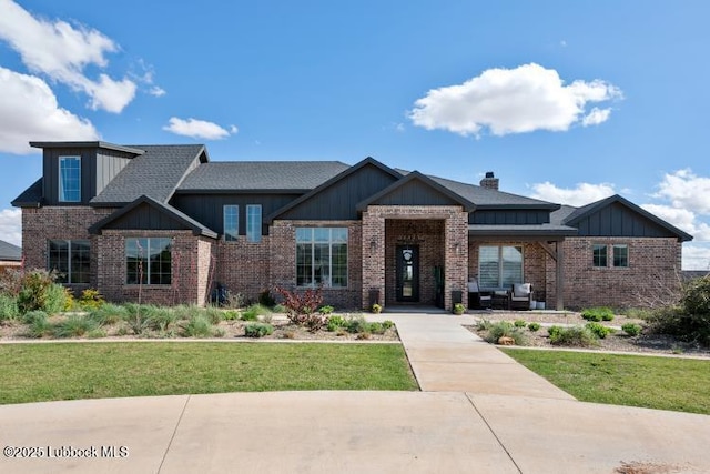 1055 Kitty Ln, New Home, TX 79381 - craftsman inspired home featuring brick siding, a front yard, board and batten siding, and a chimney