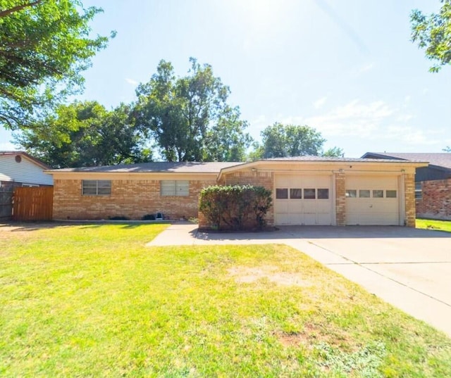 ranch-style home featuring an attached garage, brick siding, fence, driveway, and a front yard