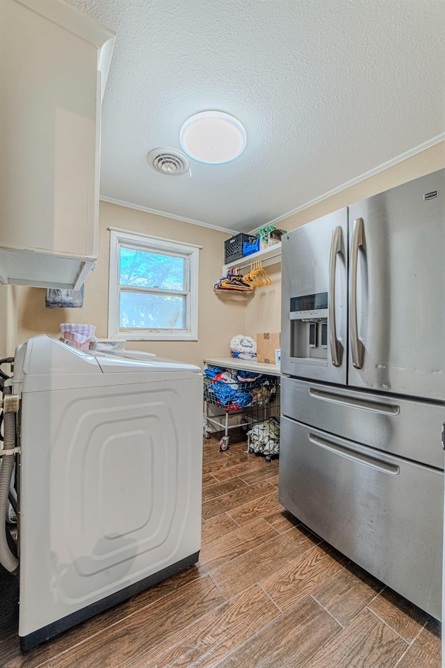 laundry room with crown molding and a textured ceiling