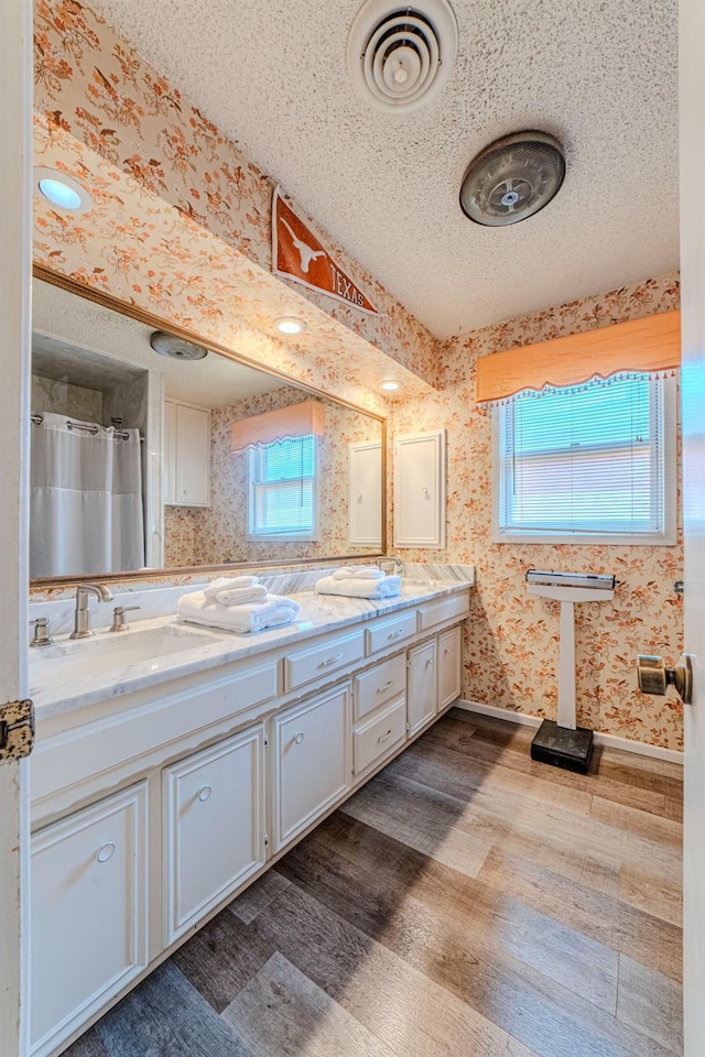 bathroom with vanity, hardwood / wood-style flooring, and a textured ceiling