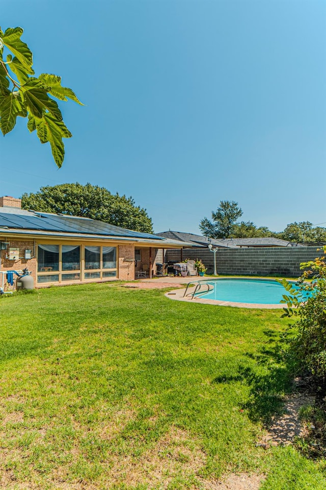 view of swimming pool with a yard and a patio area