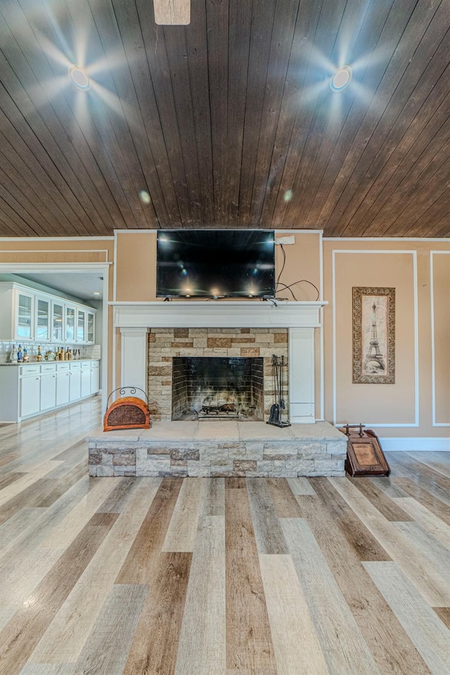 unfurnished living room with wood ceiling, a fireplace, and hardwood / wood-style flooring