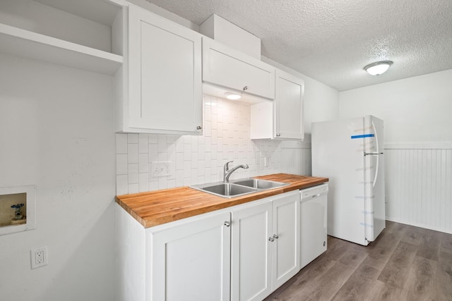 kitchen featuring wood counters, sink, white appliances, and white cabinetry